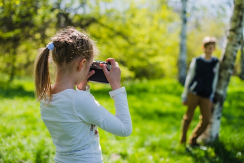 Girl taking picture of brother